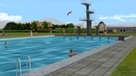 Freibad mit Sprungturm, Schwimmbecken, Duschbecken und Eingangsgebude.